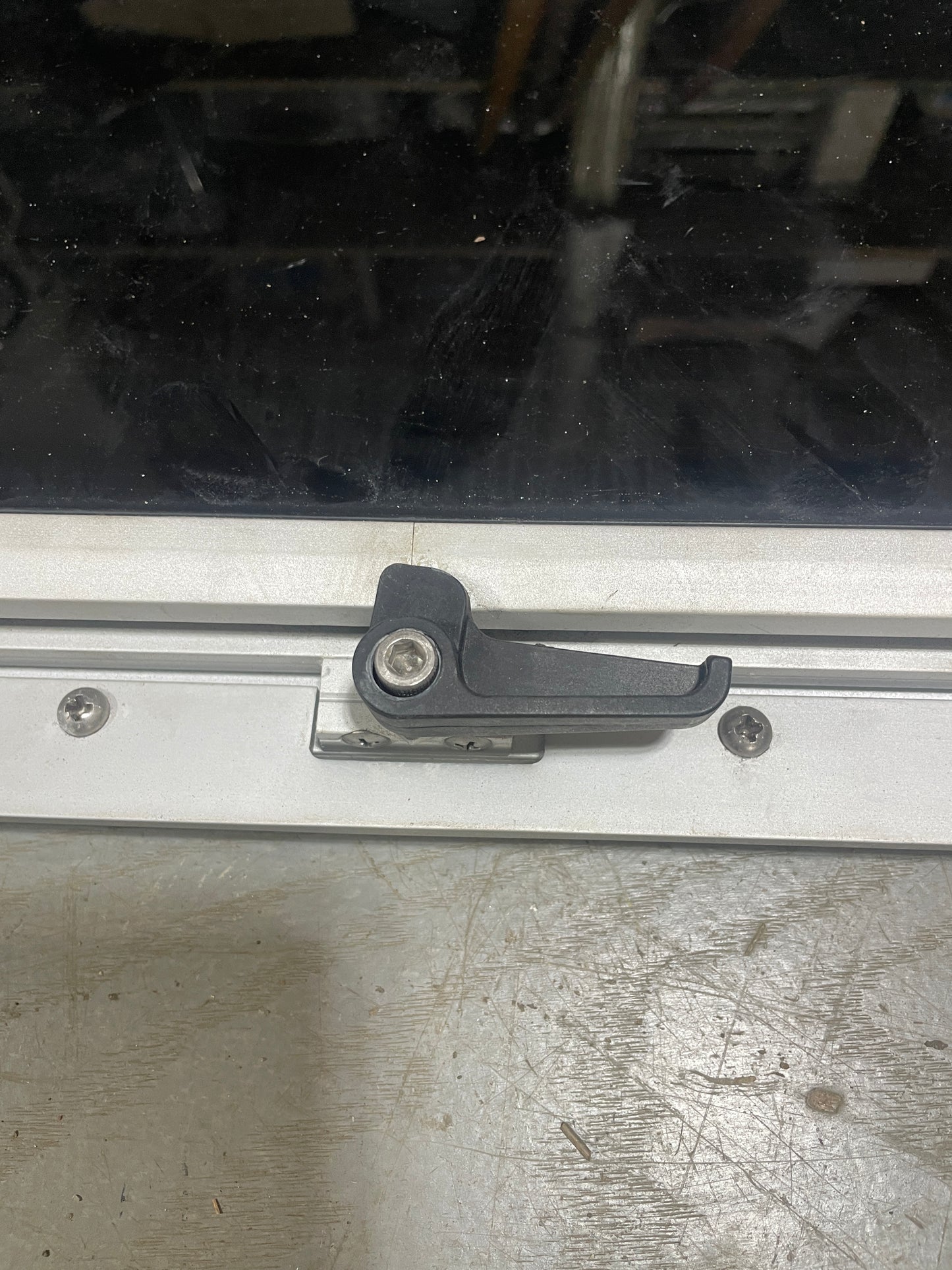 Window wiper blade on a vehicle window with a blurred background