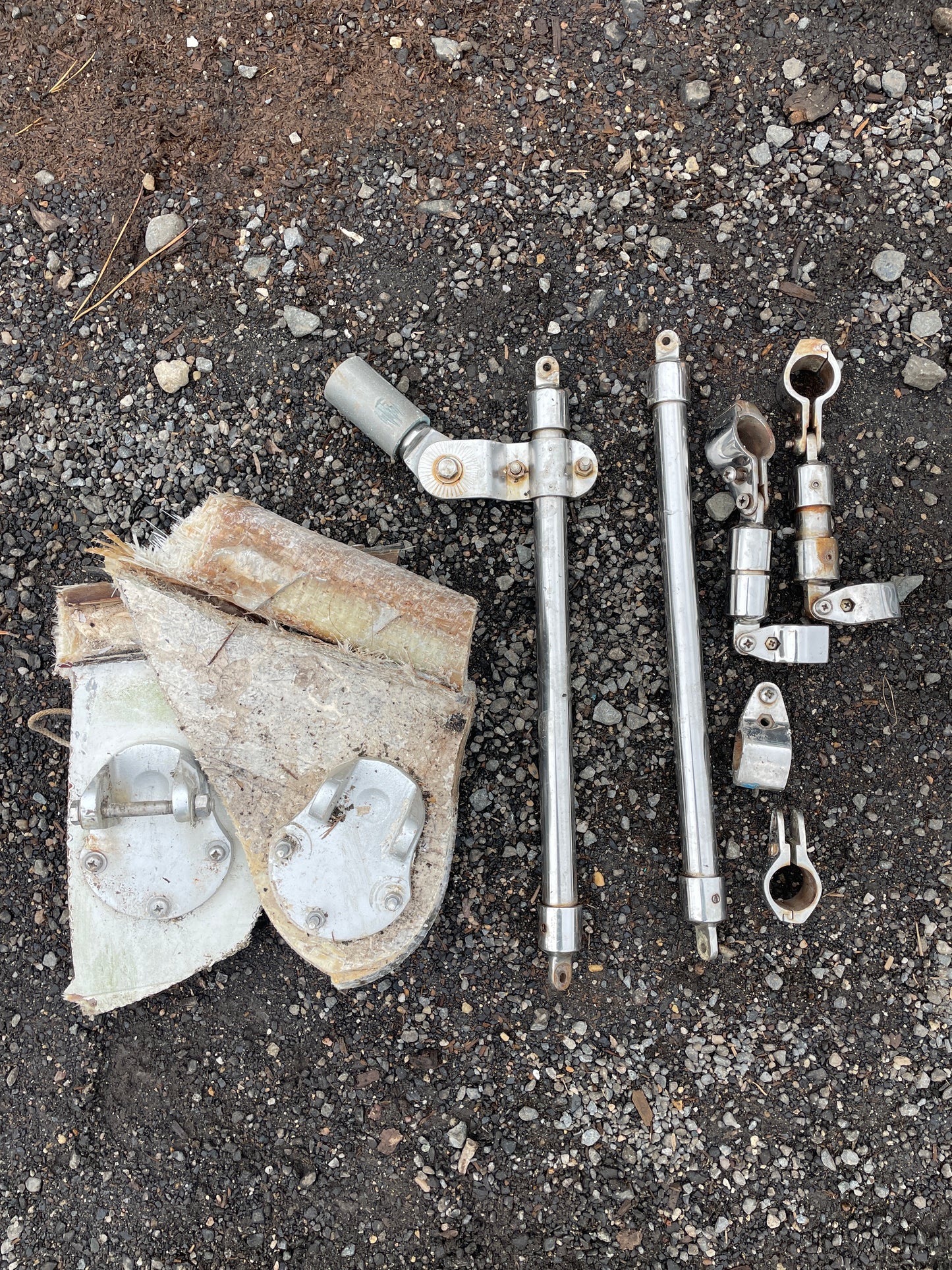 Metal components and a piece of concrete on a rough surface