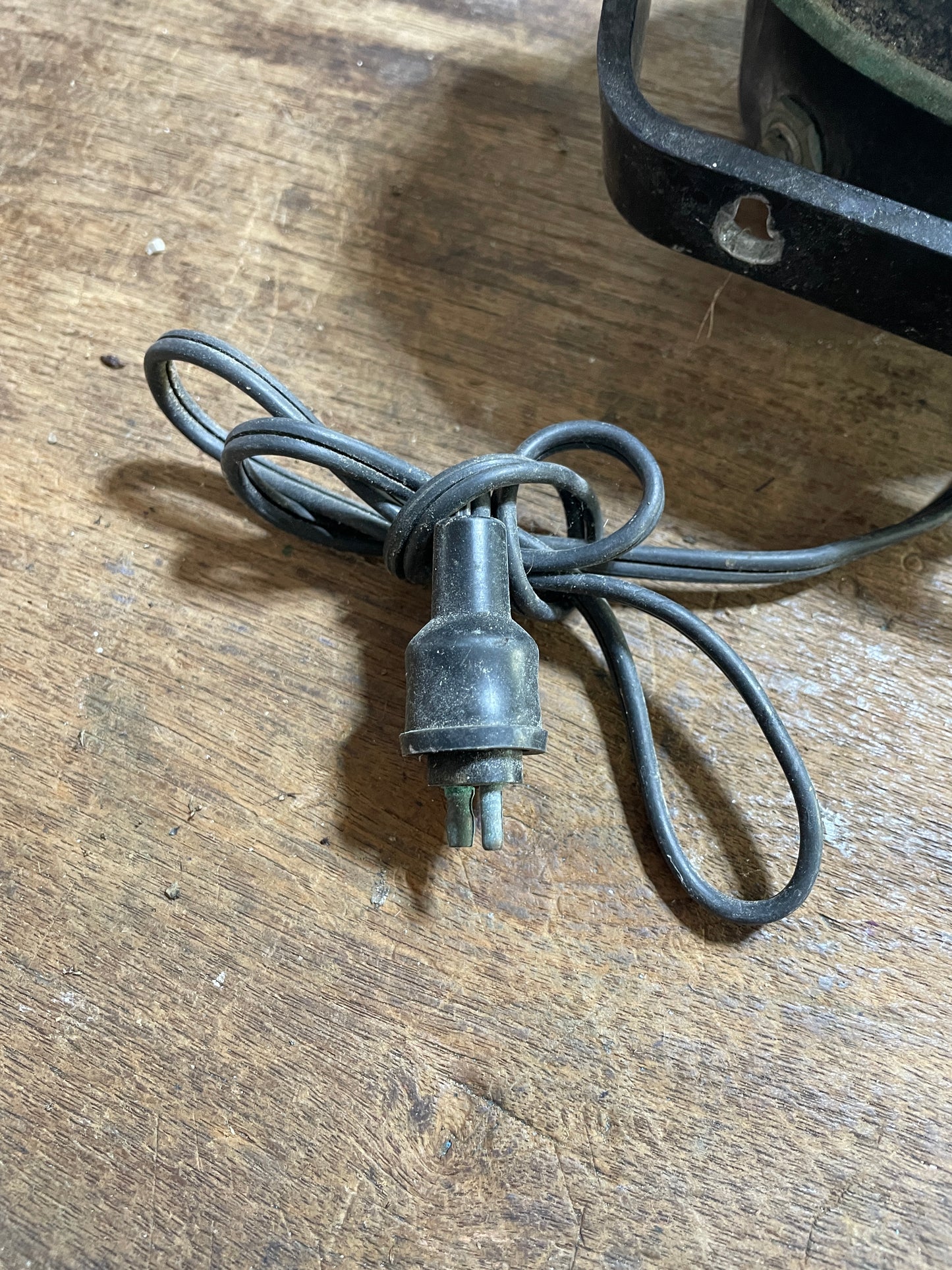 Old-style electric plug on a wooden surface