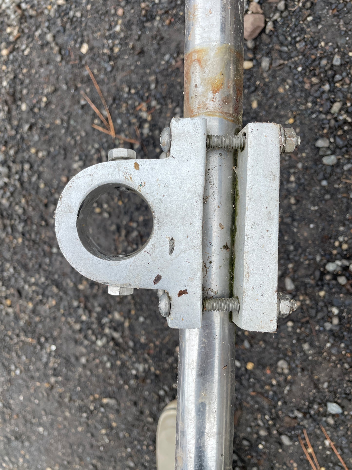 Metal bracket with bolts on a concrete surface