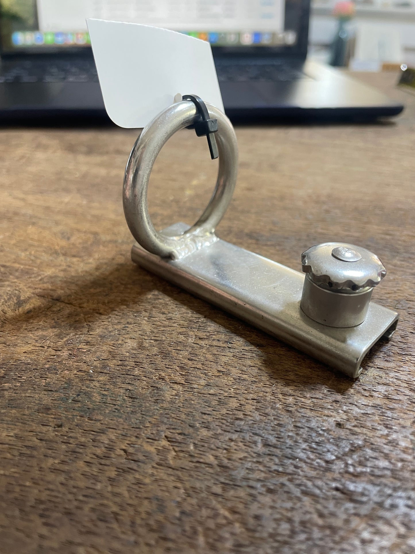 Metal handle on a wooden surface with a blurred background
