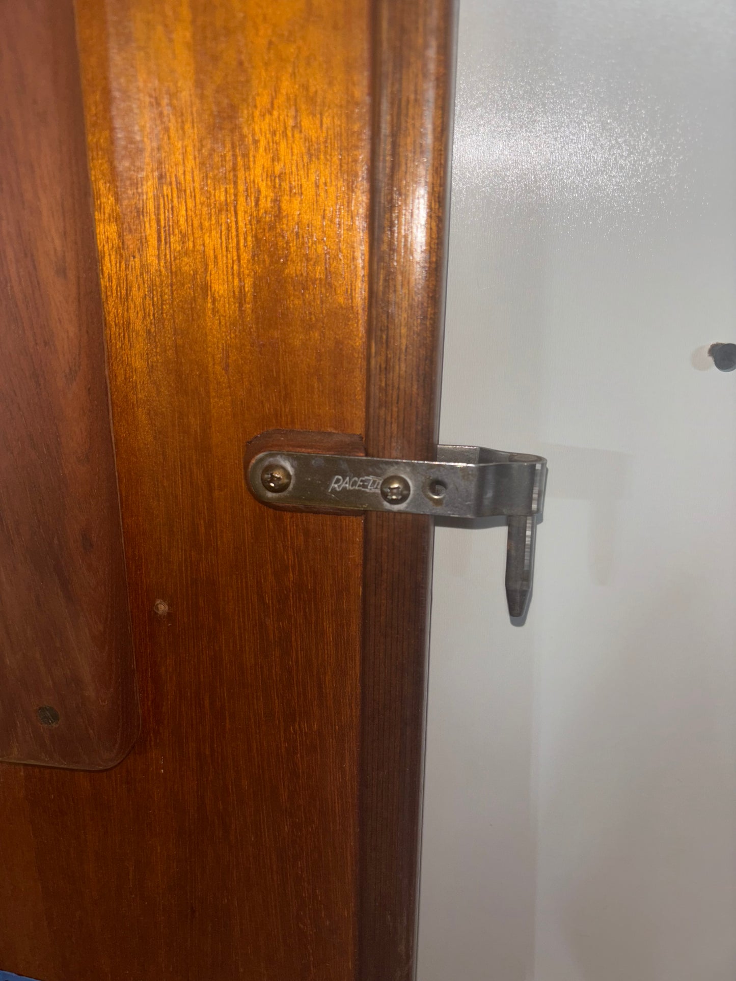 Wooden door with a metal latch on a white background