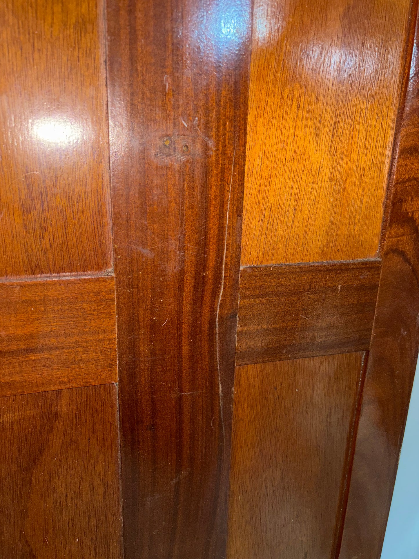 Close-up of a wooden panel with visible grain and finish.