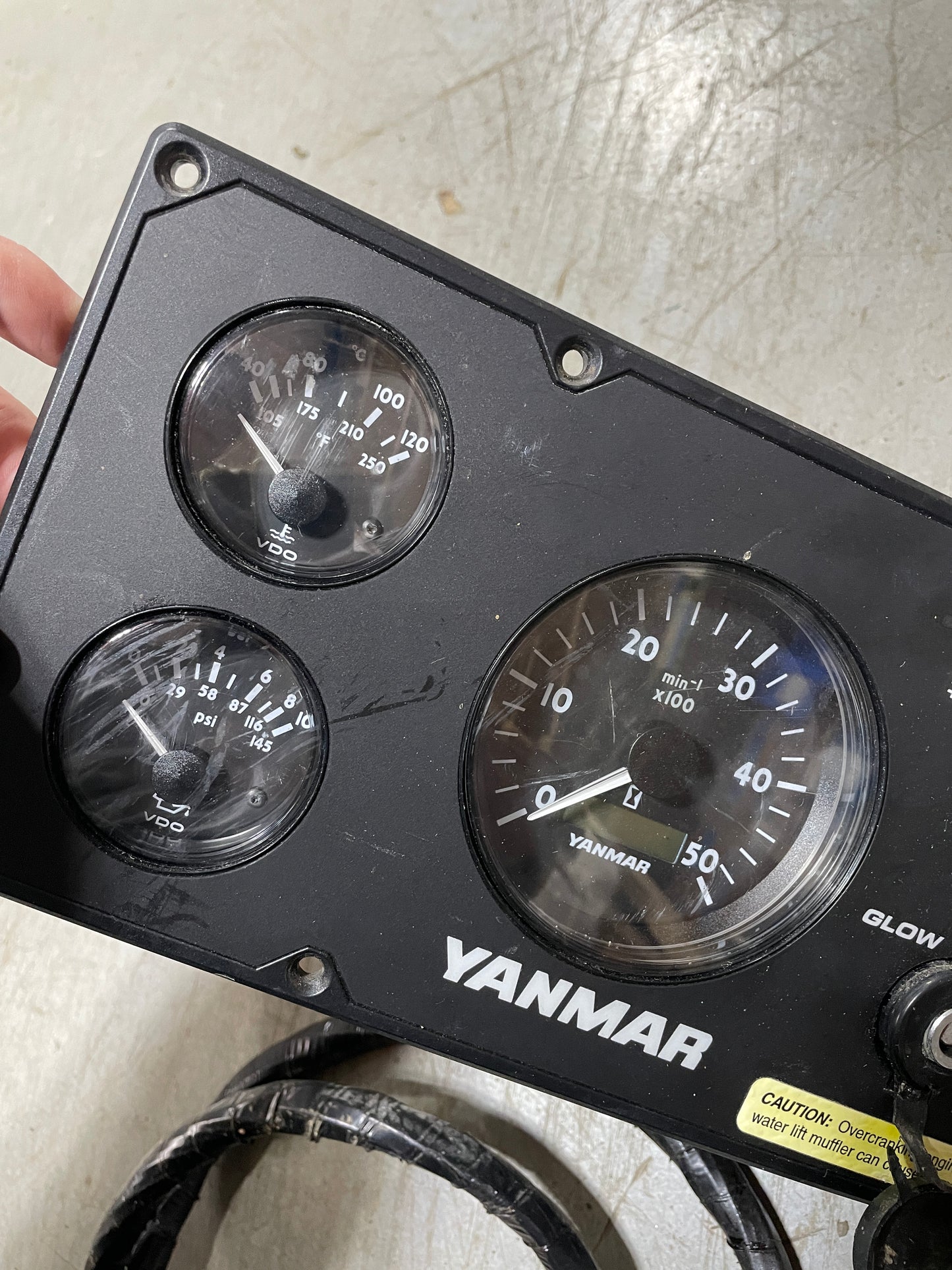 Yanmar gauge panel with three gauges on a metallic surface