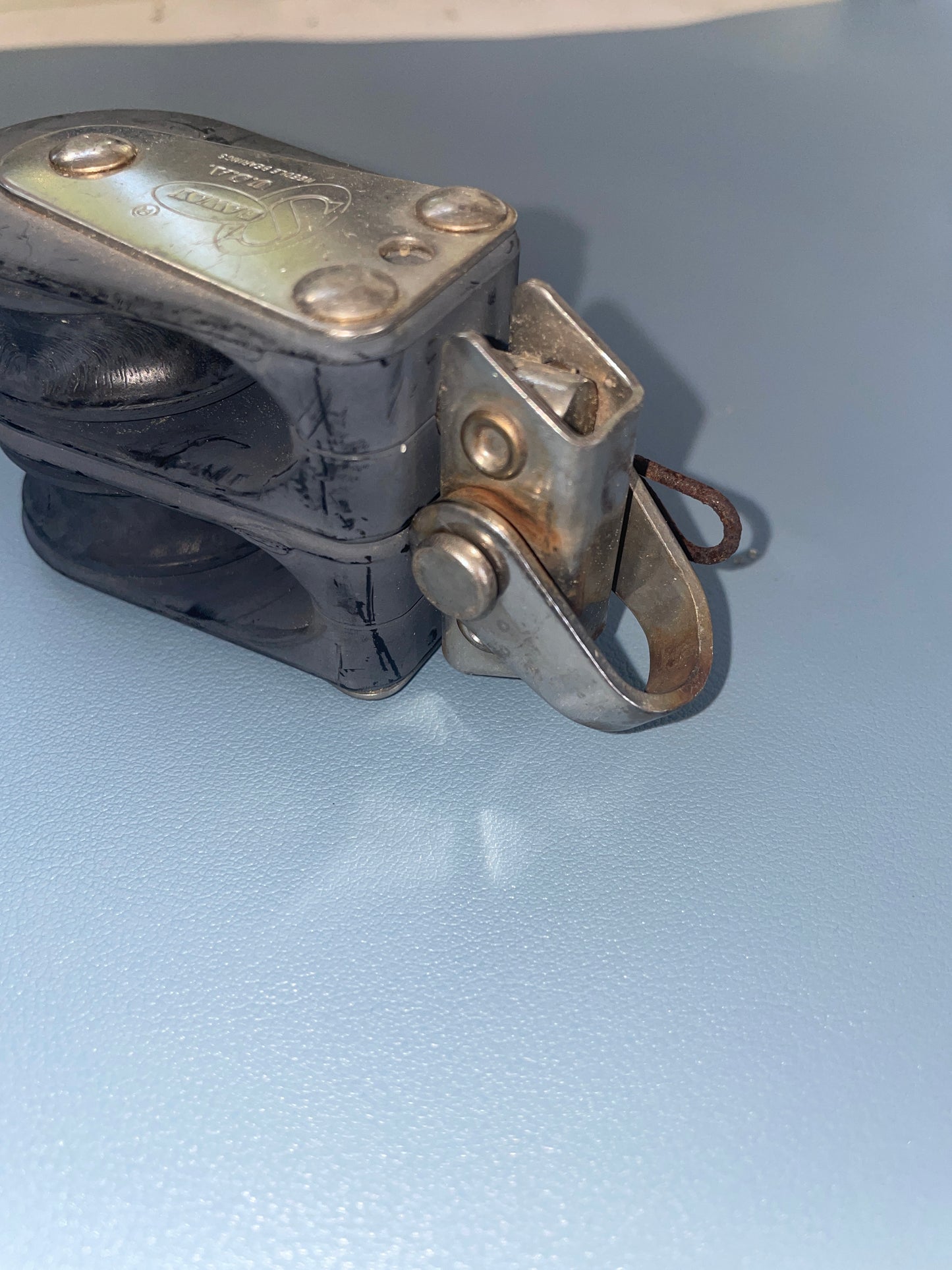 Metal clip or latch on a light blue background