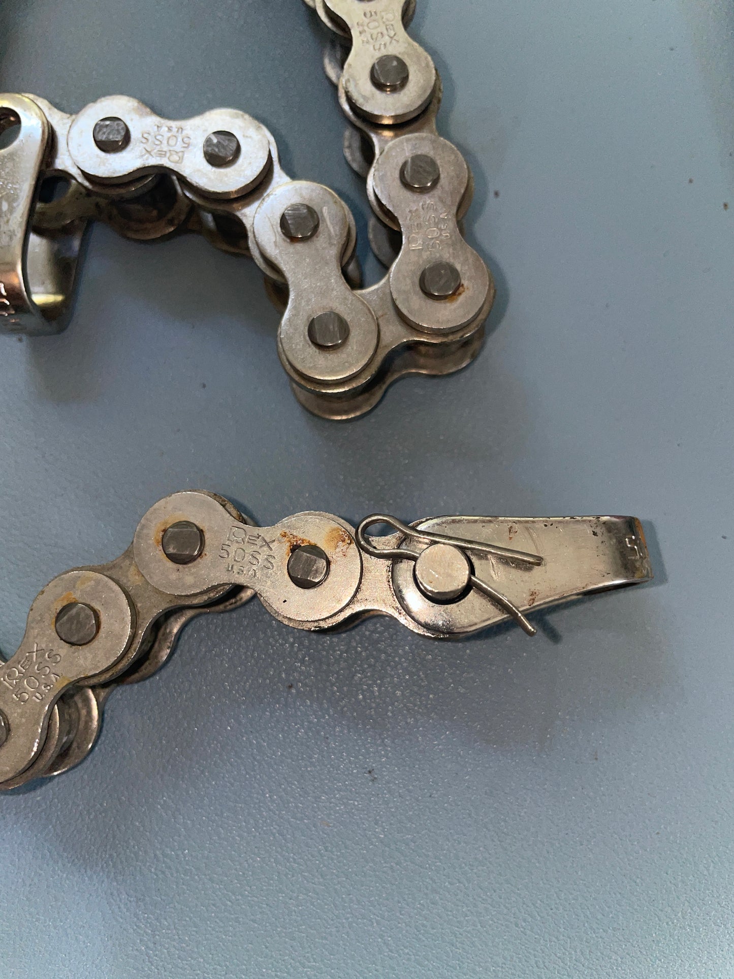 Bicycle chain with a link remover on a gray background