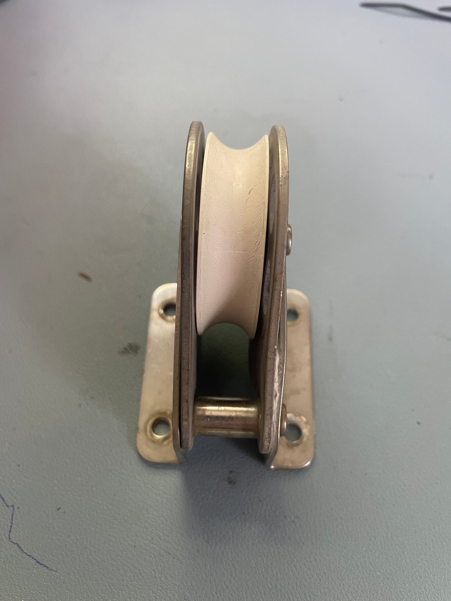 Metal pulley system mounted on a plain wall