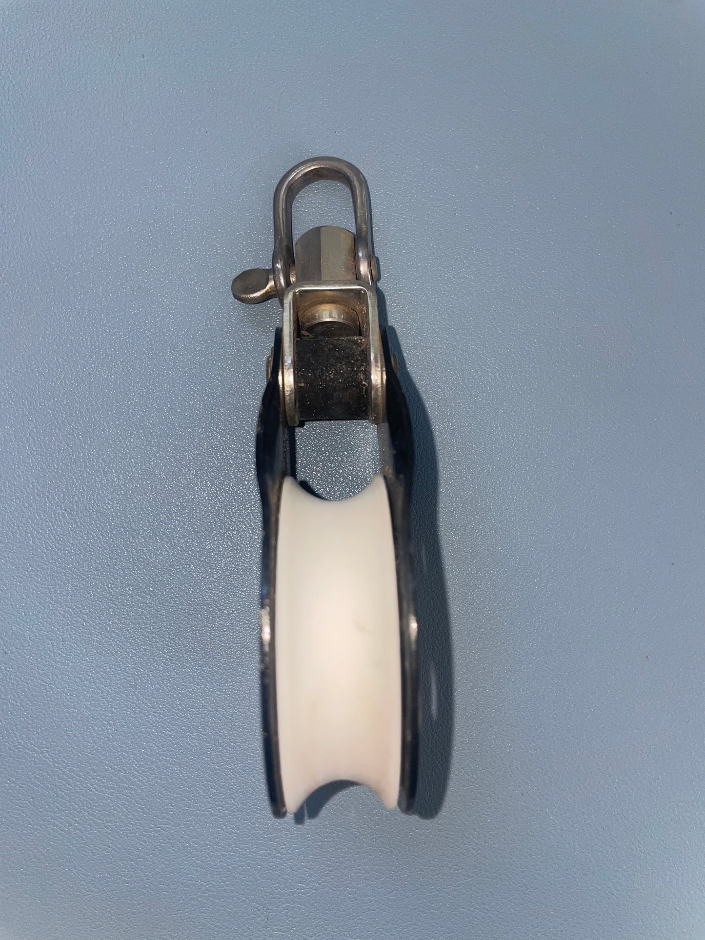 Metallic pulley system on a gray background