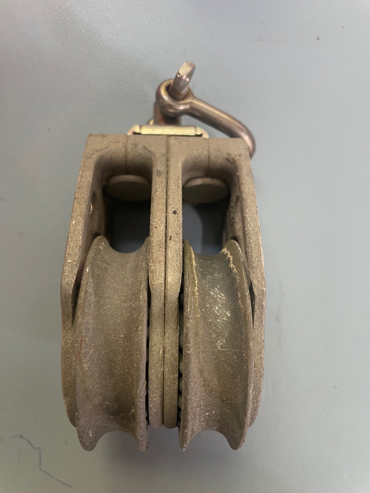 Metal pulley system on a gray background