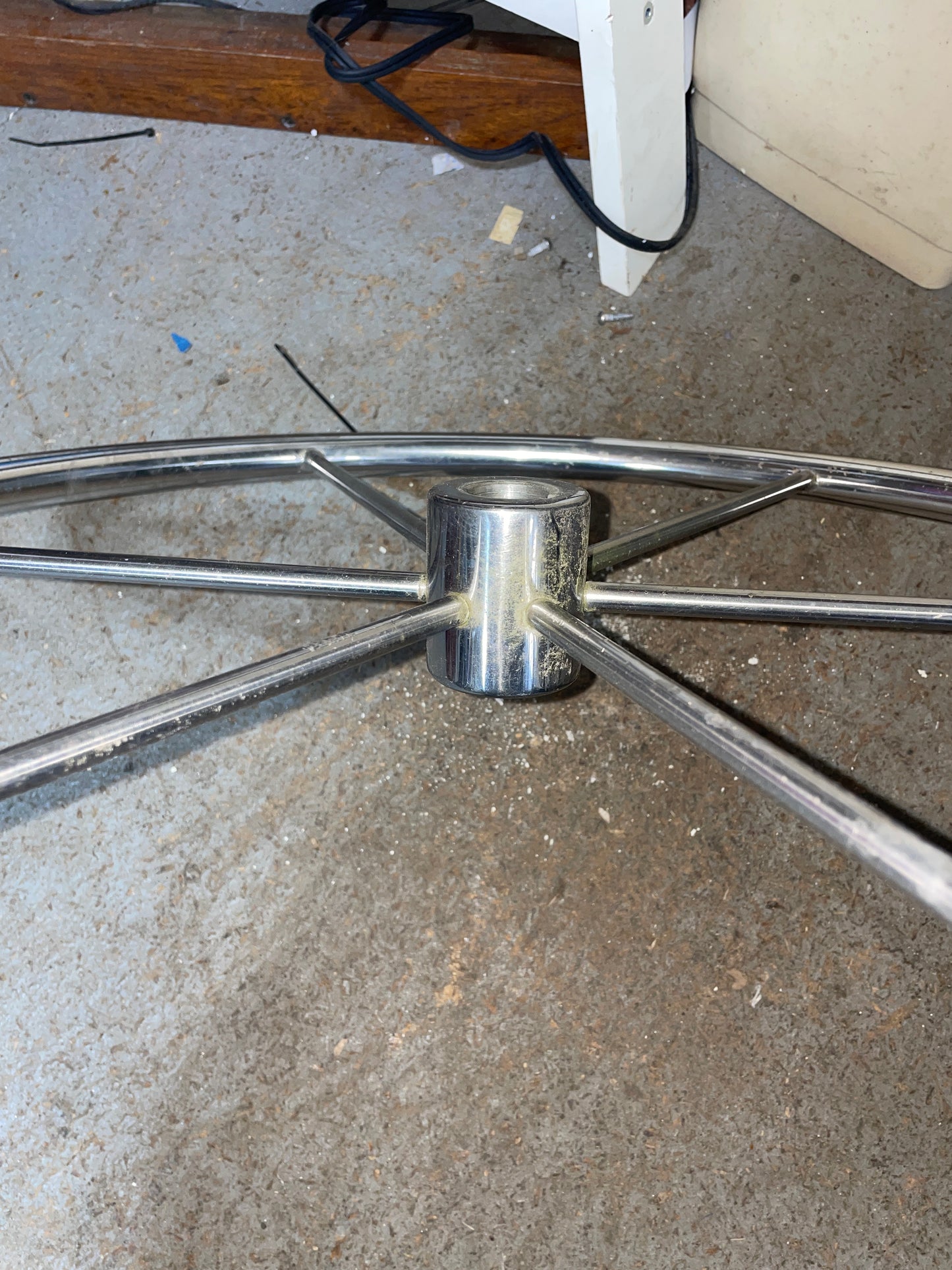 Metallic chair base on a concrete floor