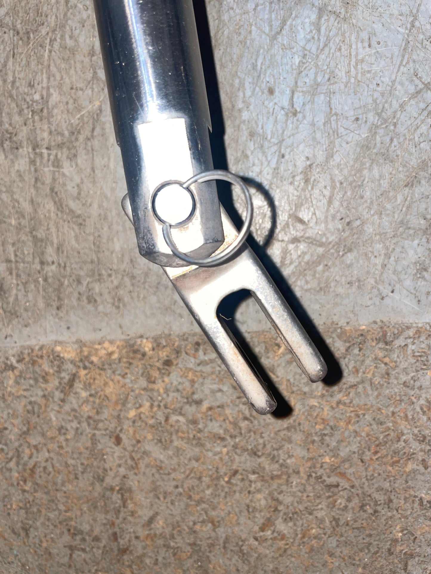 Metallic tool with a ring on a textured surface