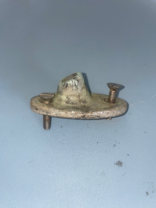 Metal bracket with screws on a light blue background