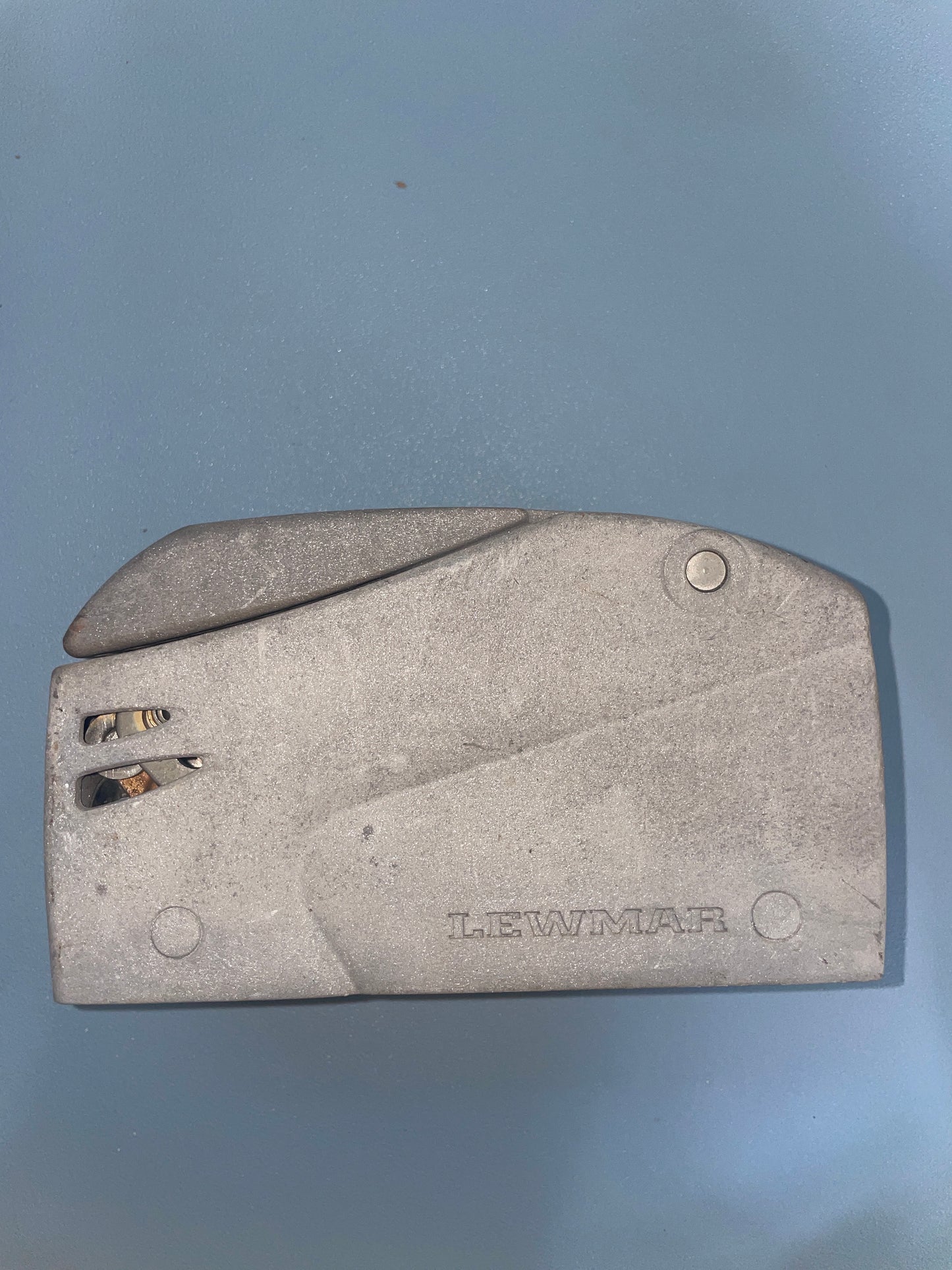 Metal tool with 'LEWMAR' branding on a gray background