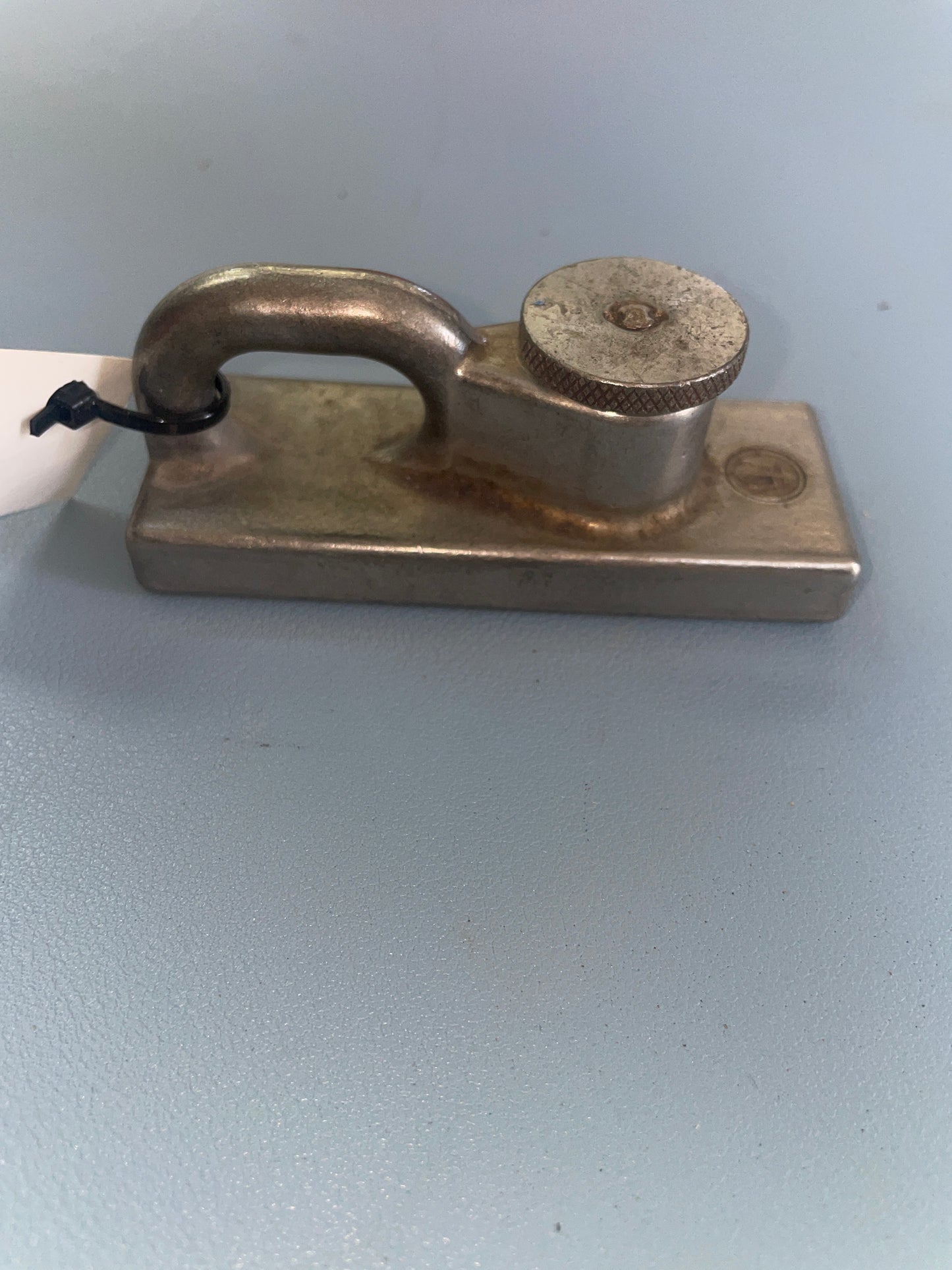 Metallic door handle on a light gray background