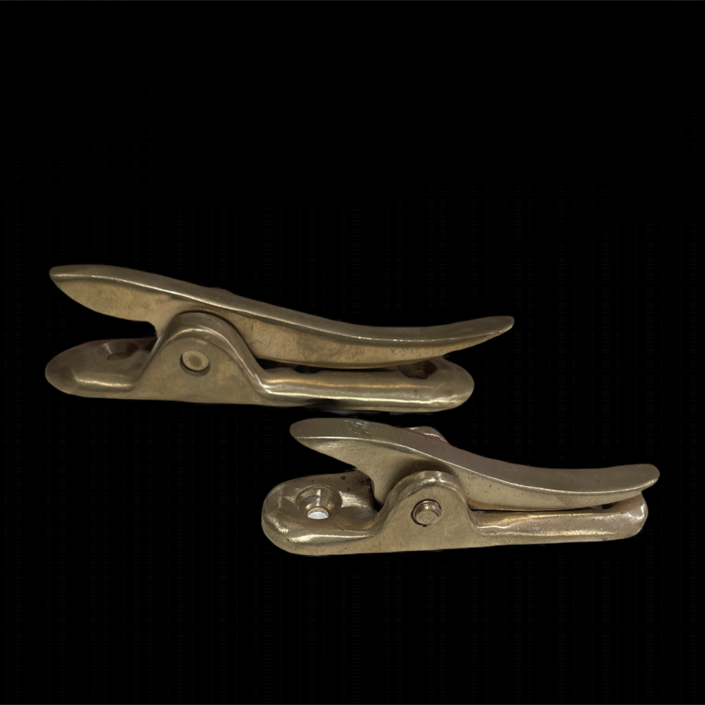 Two metallic clips on a black background