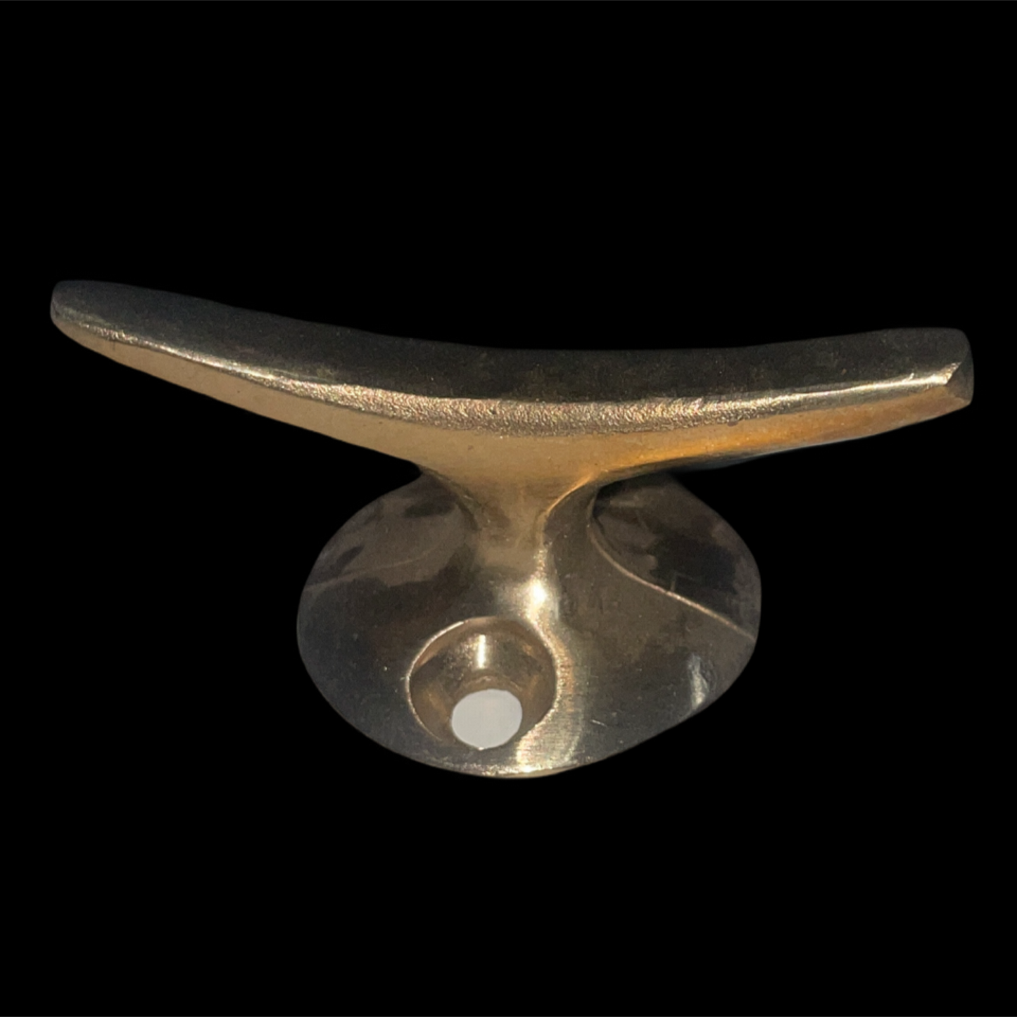 Gold metal cleat on a black background