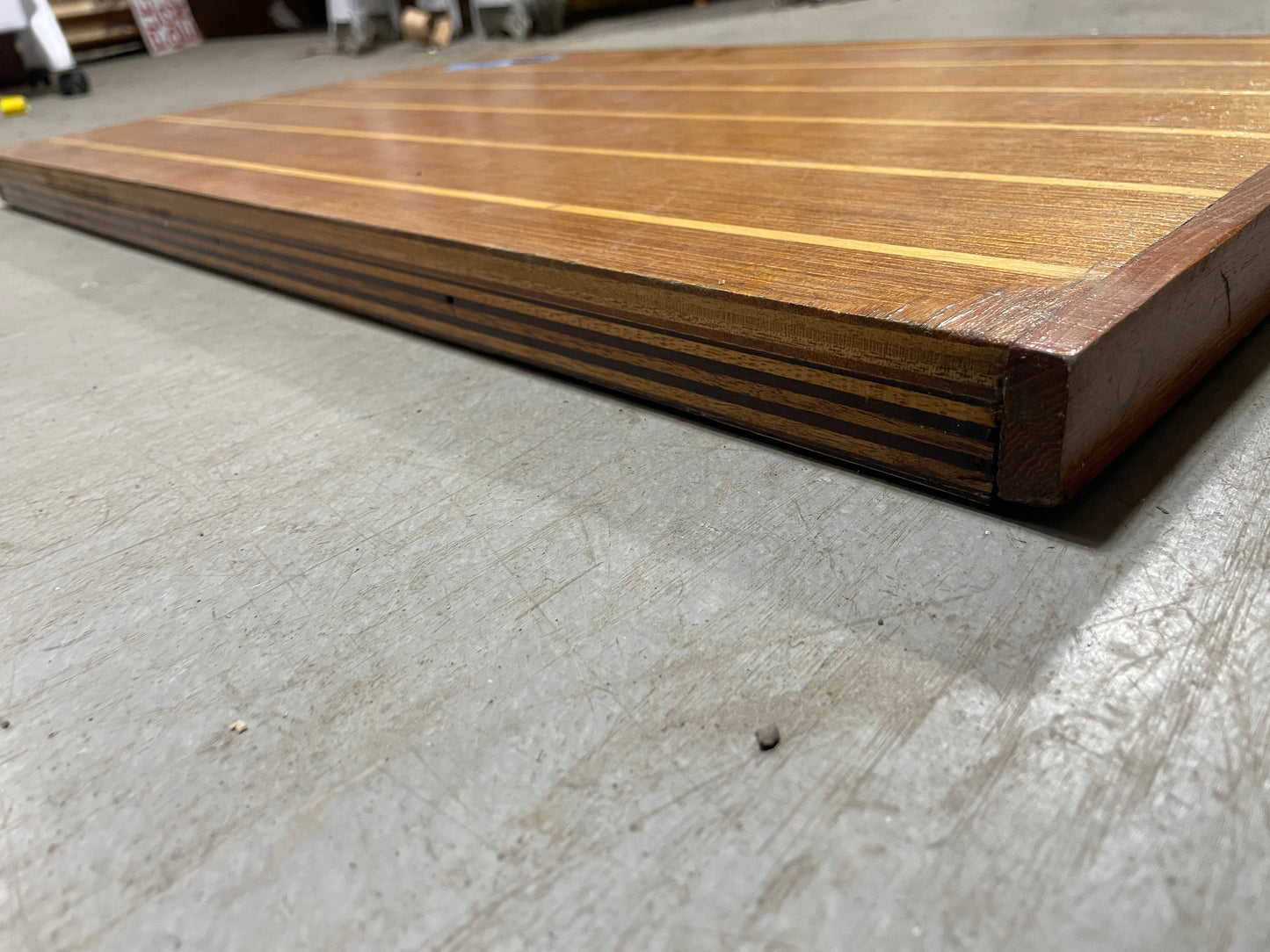 Wooden deck board on a concrete floor