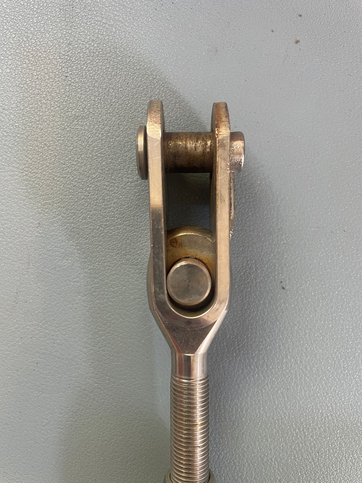 Metal clevis pin on a gray background