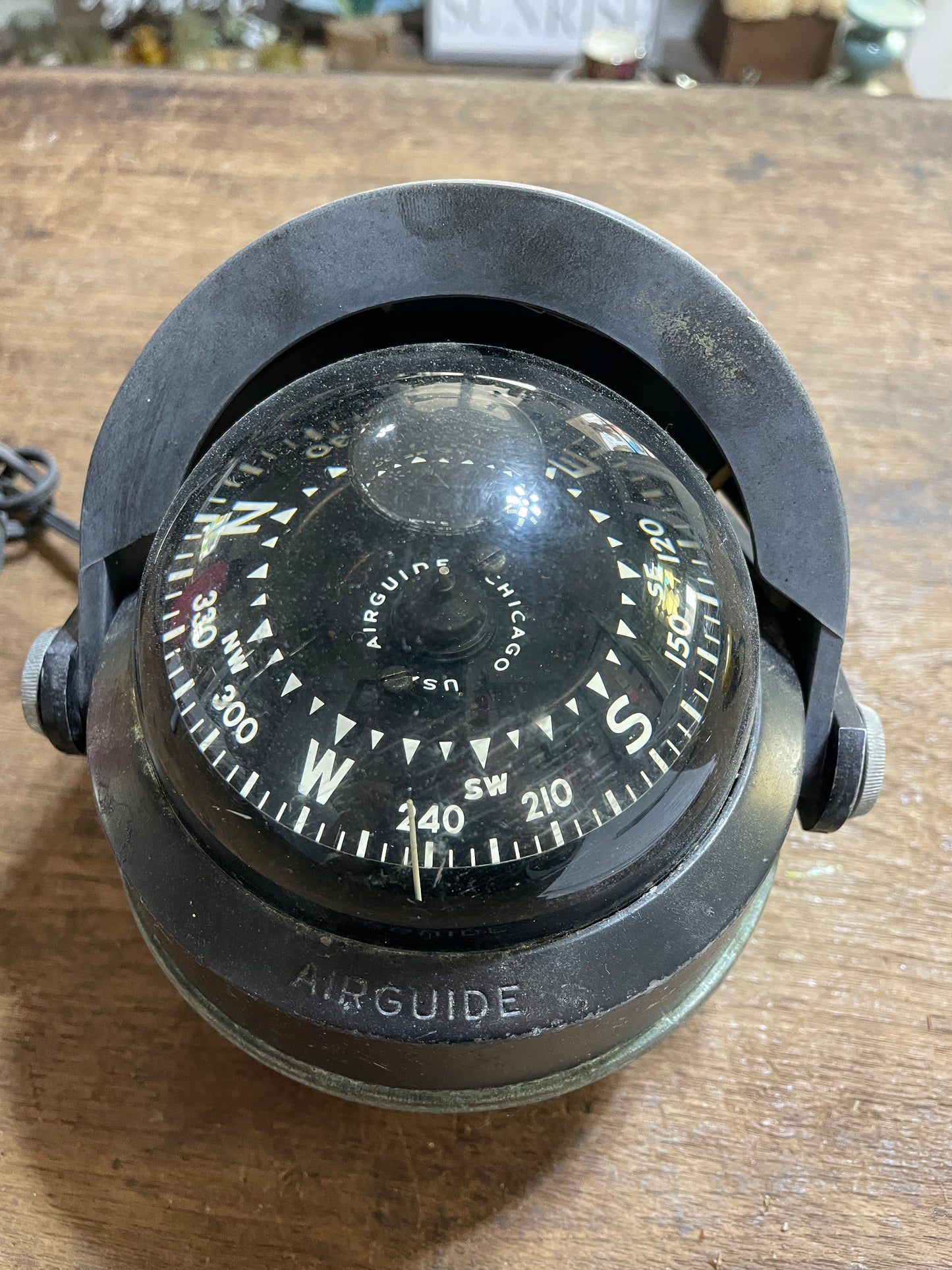 Vintage-style compass on a wooden surface