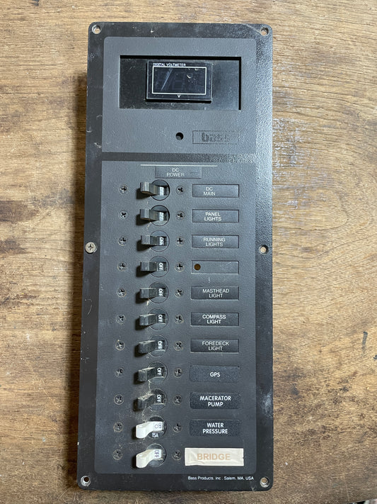 Control panel with multiple switches on a wooden surface
