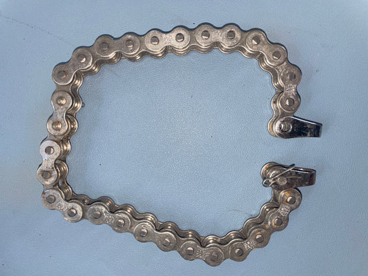 Metallic chain forming a rectangular frame on a light blue background