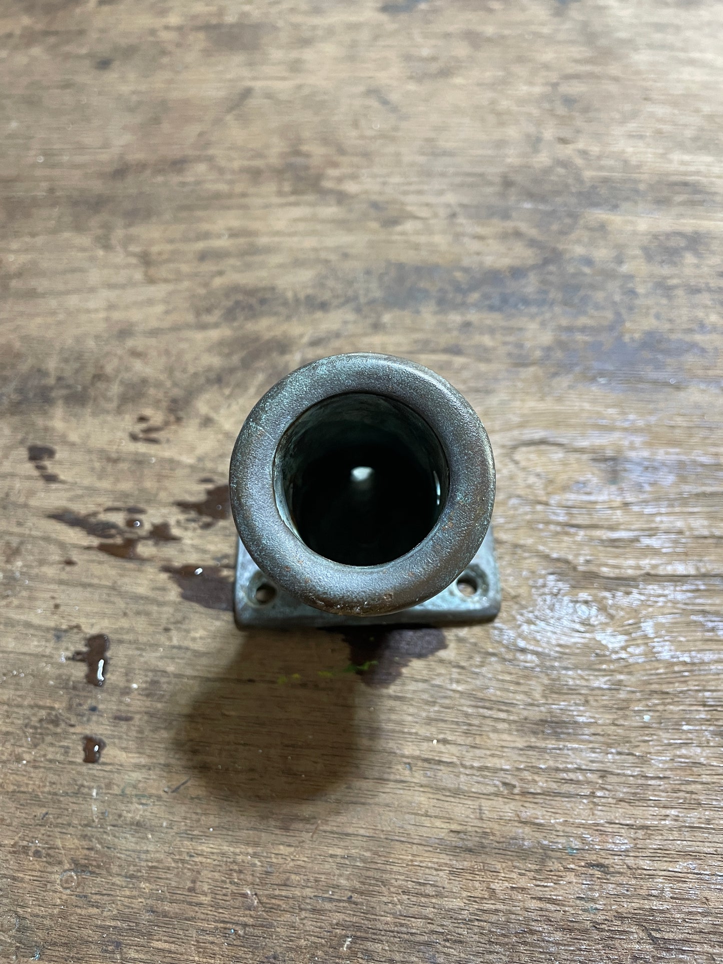 Metallic socket on a wooden surface