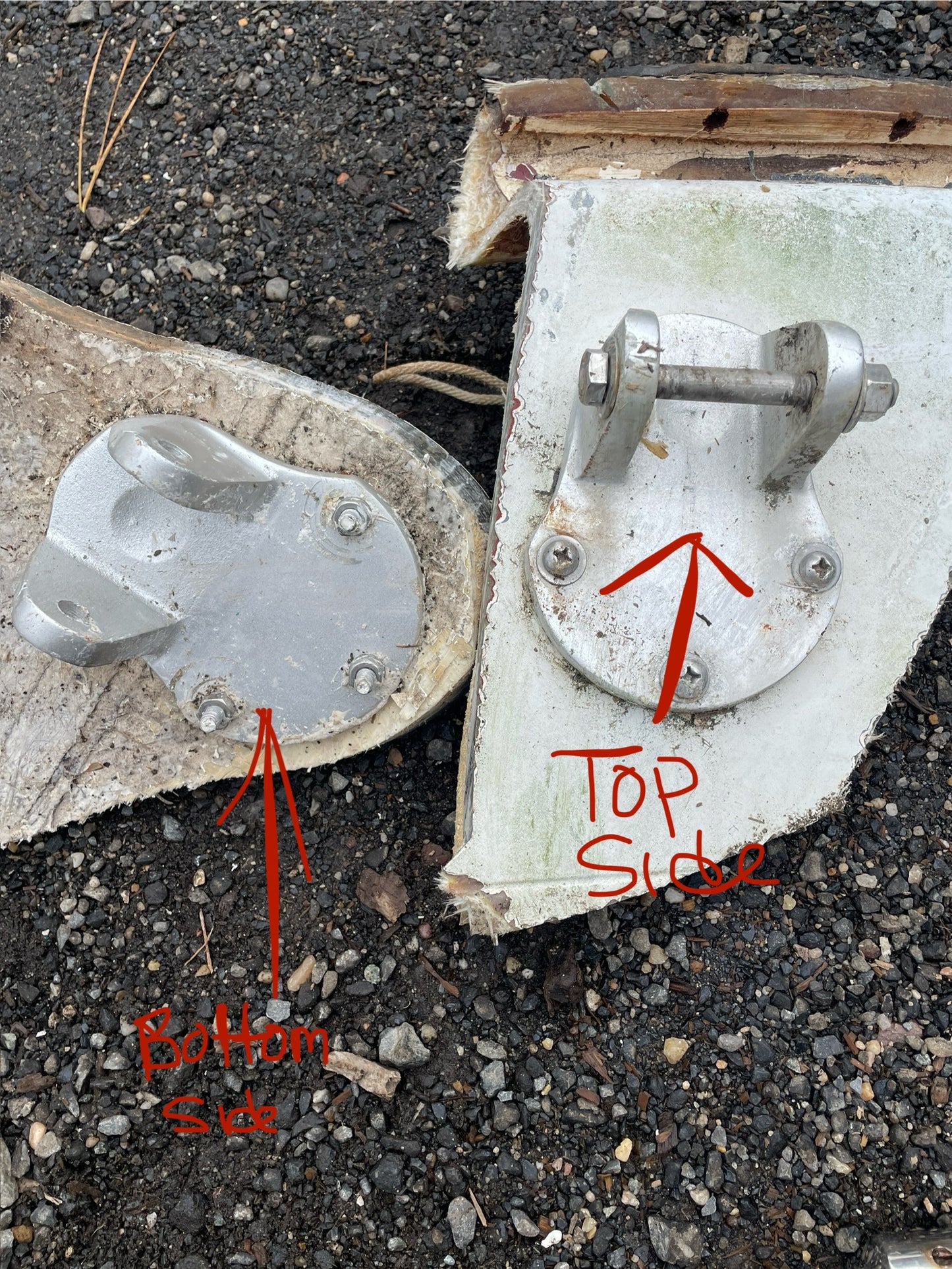 Metal component with labeled top and bottom sides on a dark surface