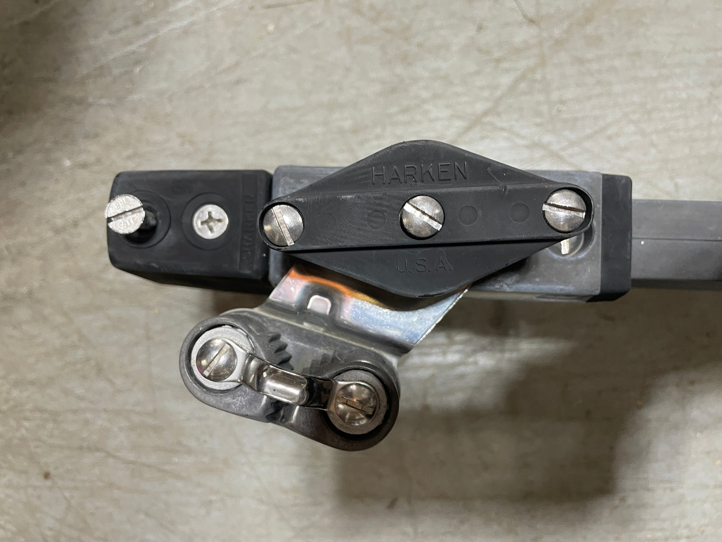 Metal bracket with screws on a textured surface