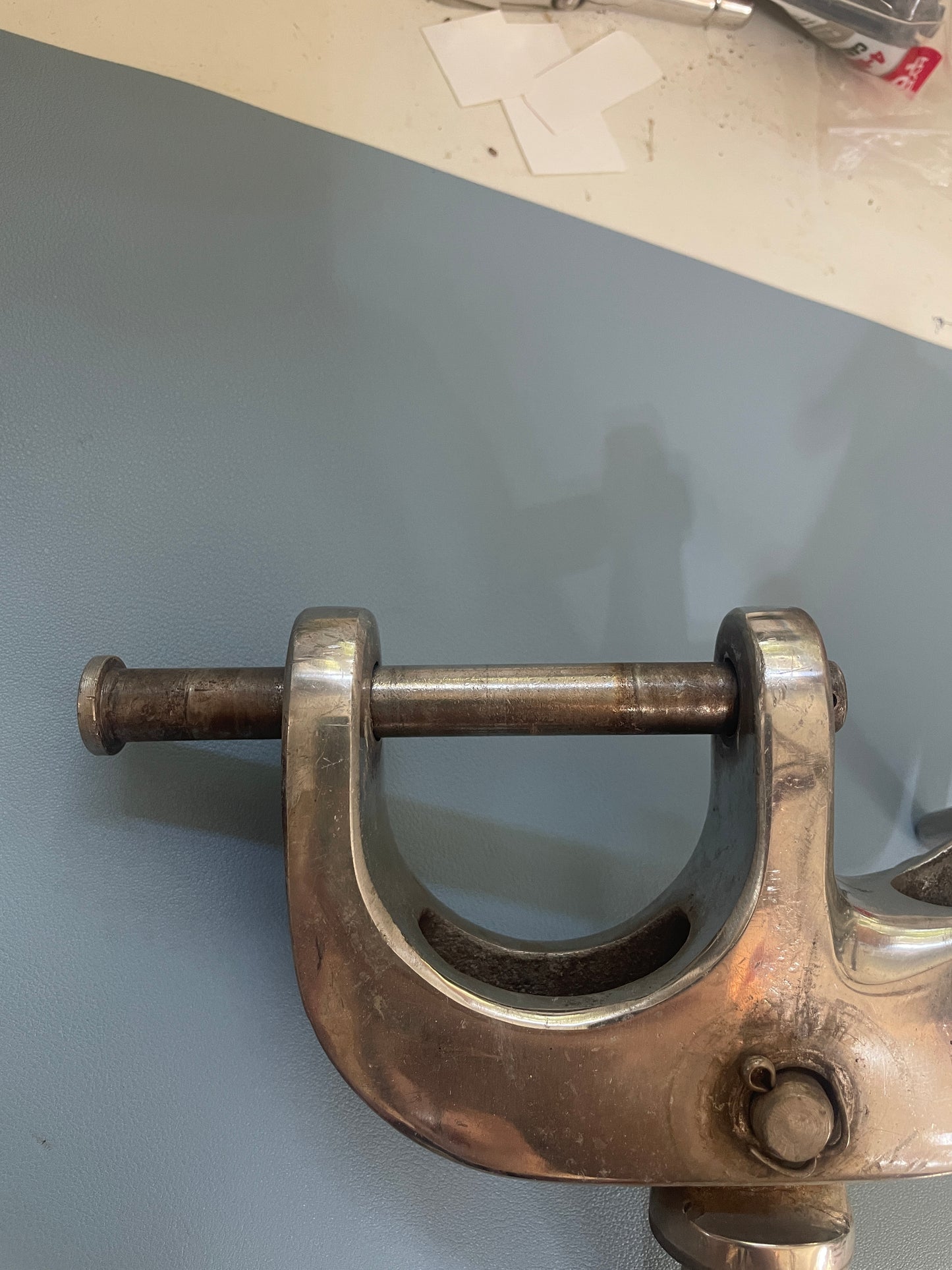 Metal C-clamp on a gray surface