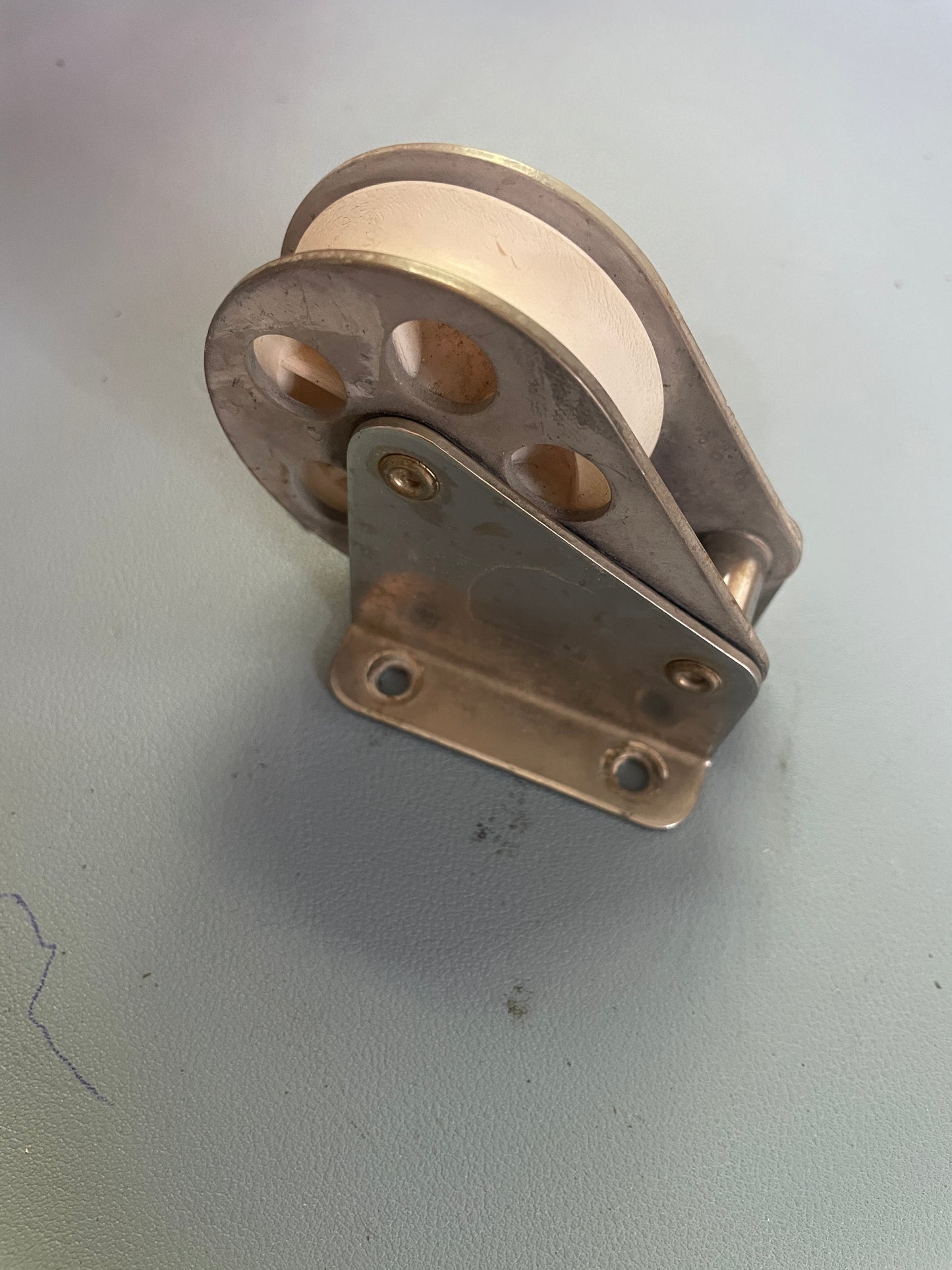 Metal pulley system on a light gray background