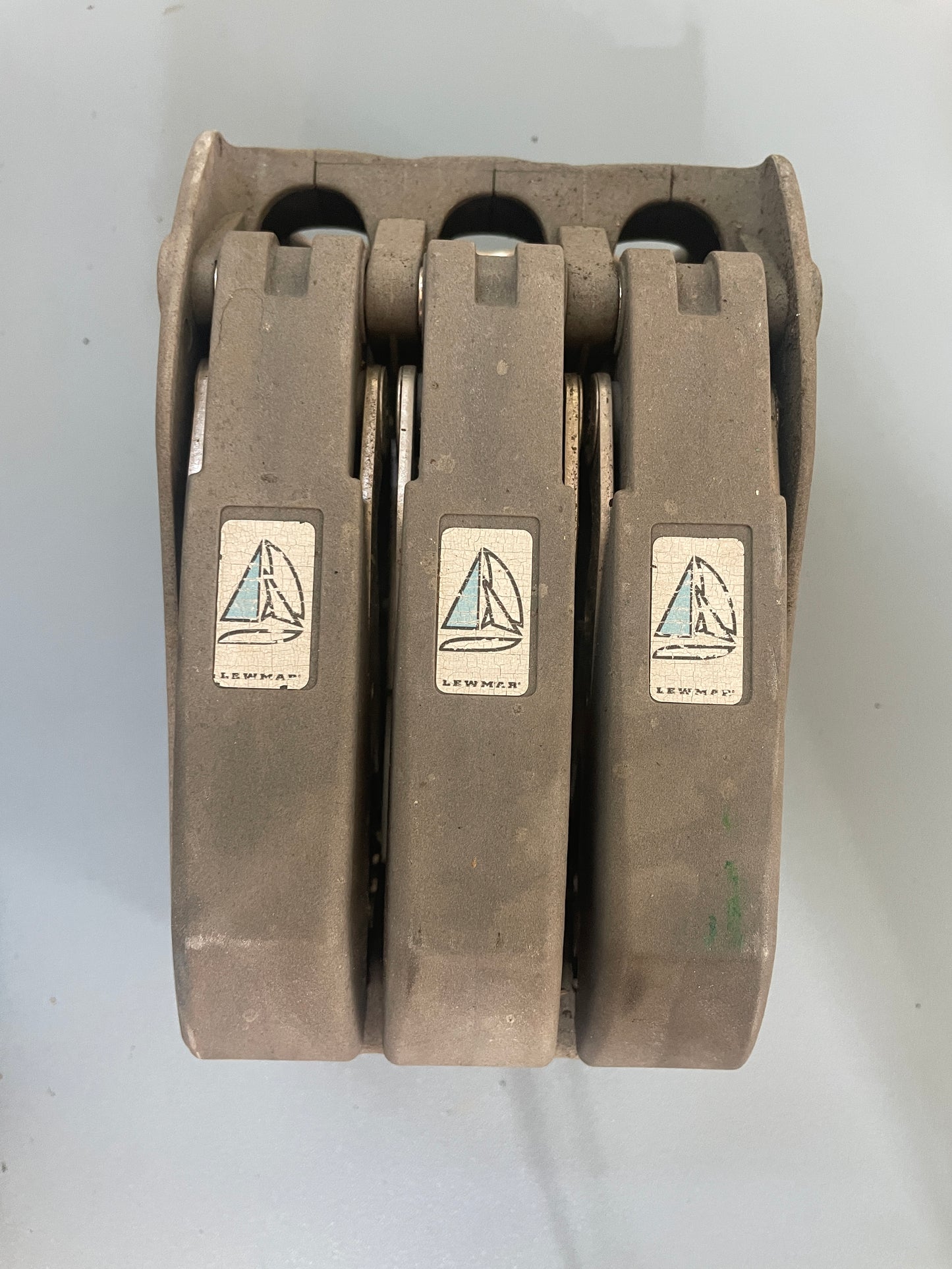 Stack of metal brake pads with visible brand logo on a white background