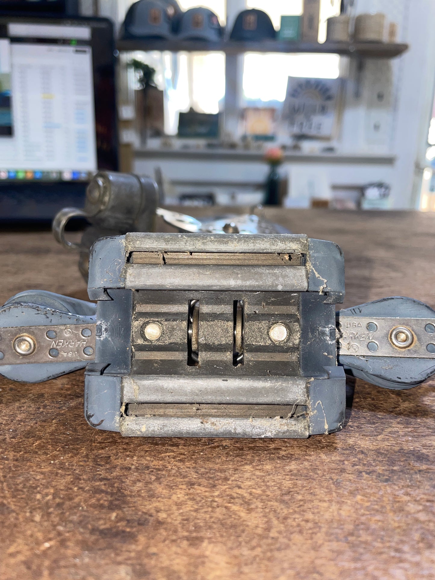 Metal tool or device attached to a wooden surface with a blurred background