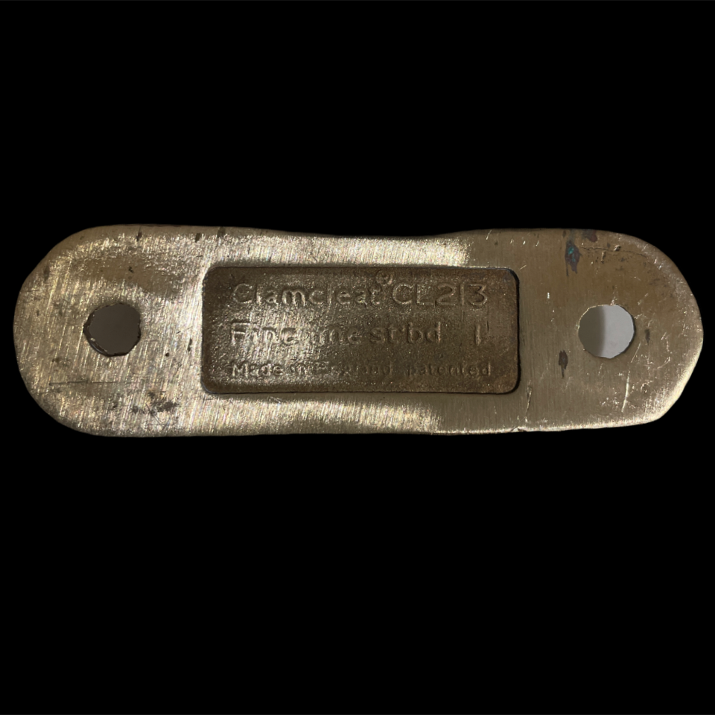 Brass plate with engraved text on a black background