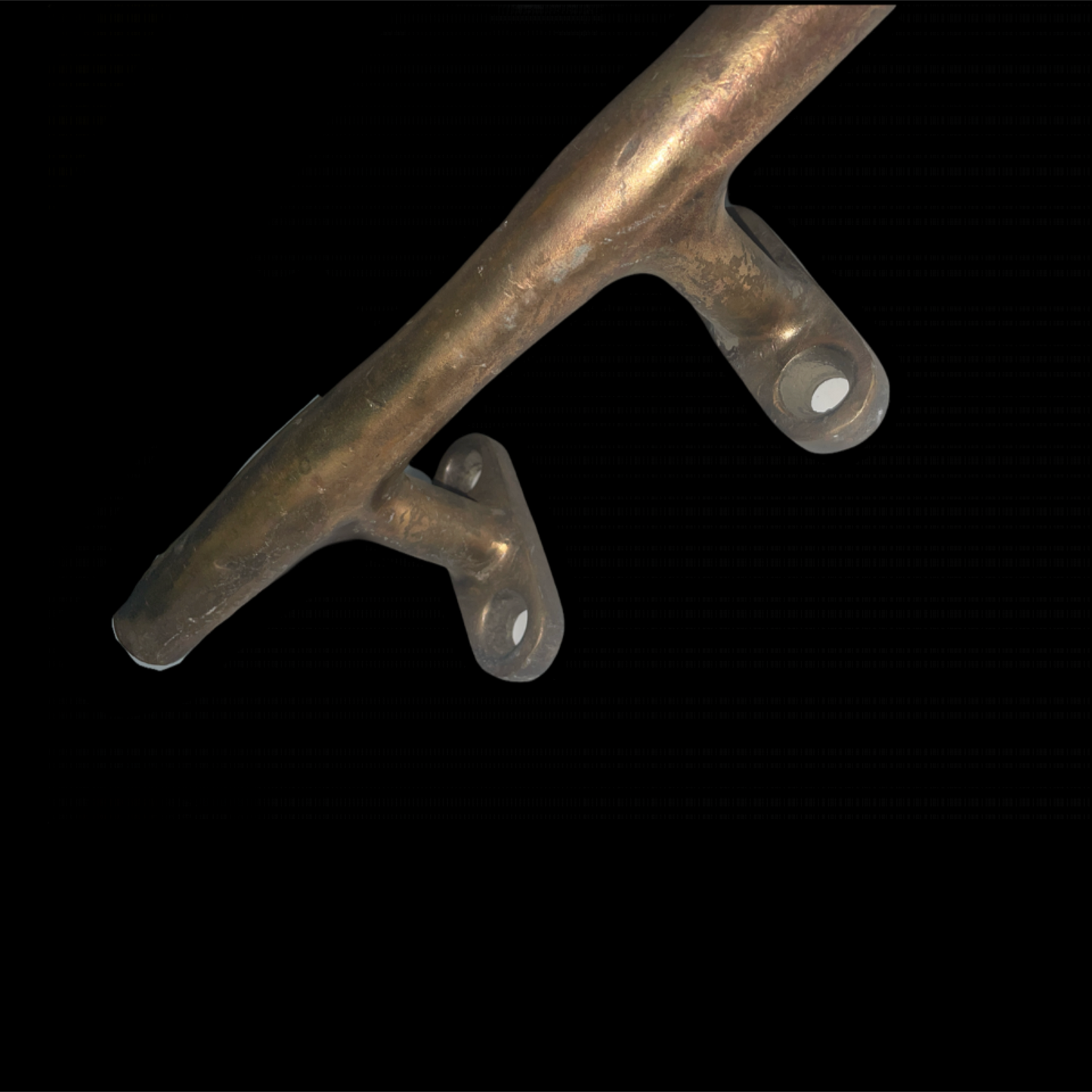 Metallic object with two circular components on a black background
