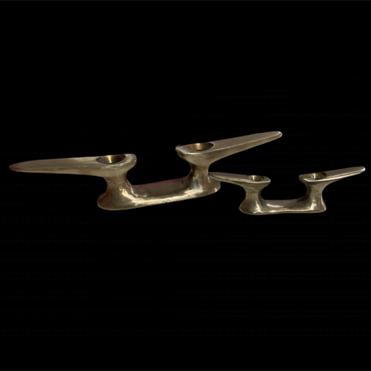 Set of three silver candle holders on a black background