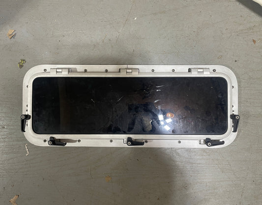 Black screen on a white frame on a gray concrete floor