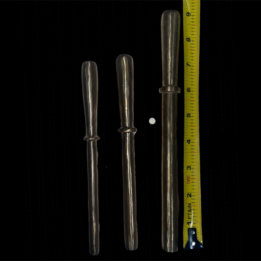 Three silver tools of varying lengths with a measuring tape on a black background