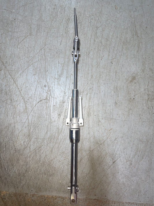 Metal steering rack on a textured gray surface
