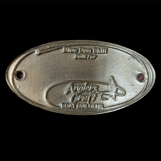 Metal plaque with 'Anglers Craft' branding on a black background