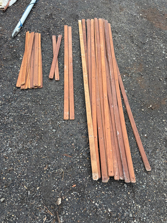 Set of wooden sticks on a dark asphalt surface