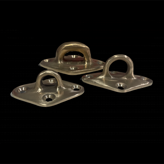 Three metallic brackets on a black background