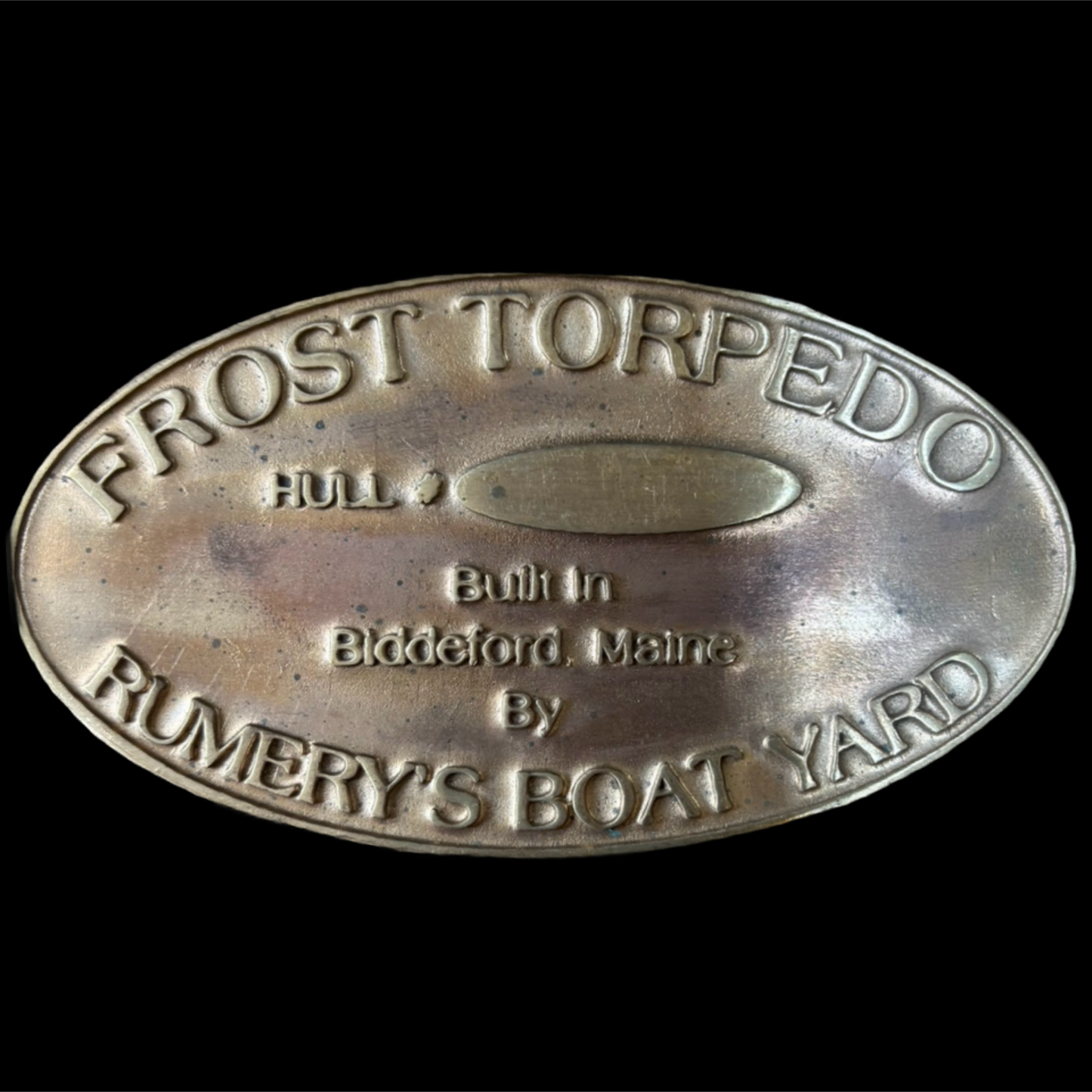 Metal plaque with 'Frost Torpedo' branding on a black background