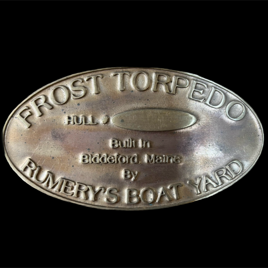Metal plaque with 'Frost Torpedo' branding on a black background