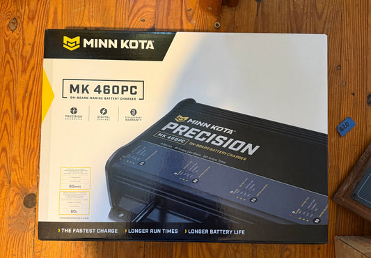 Minn Kota Precision MK 460PC fishing motor packaging on a wooden floor.