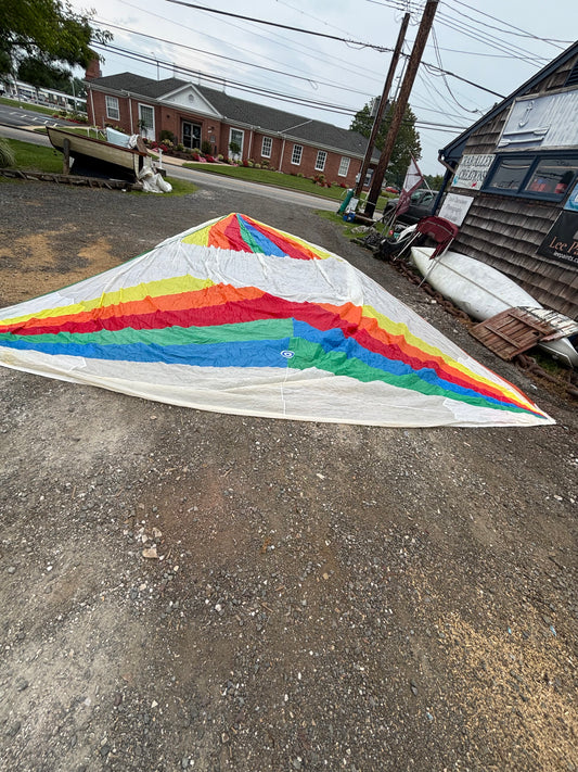 Colorful quilt on a street with residential buildings in the background