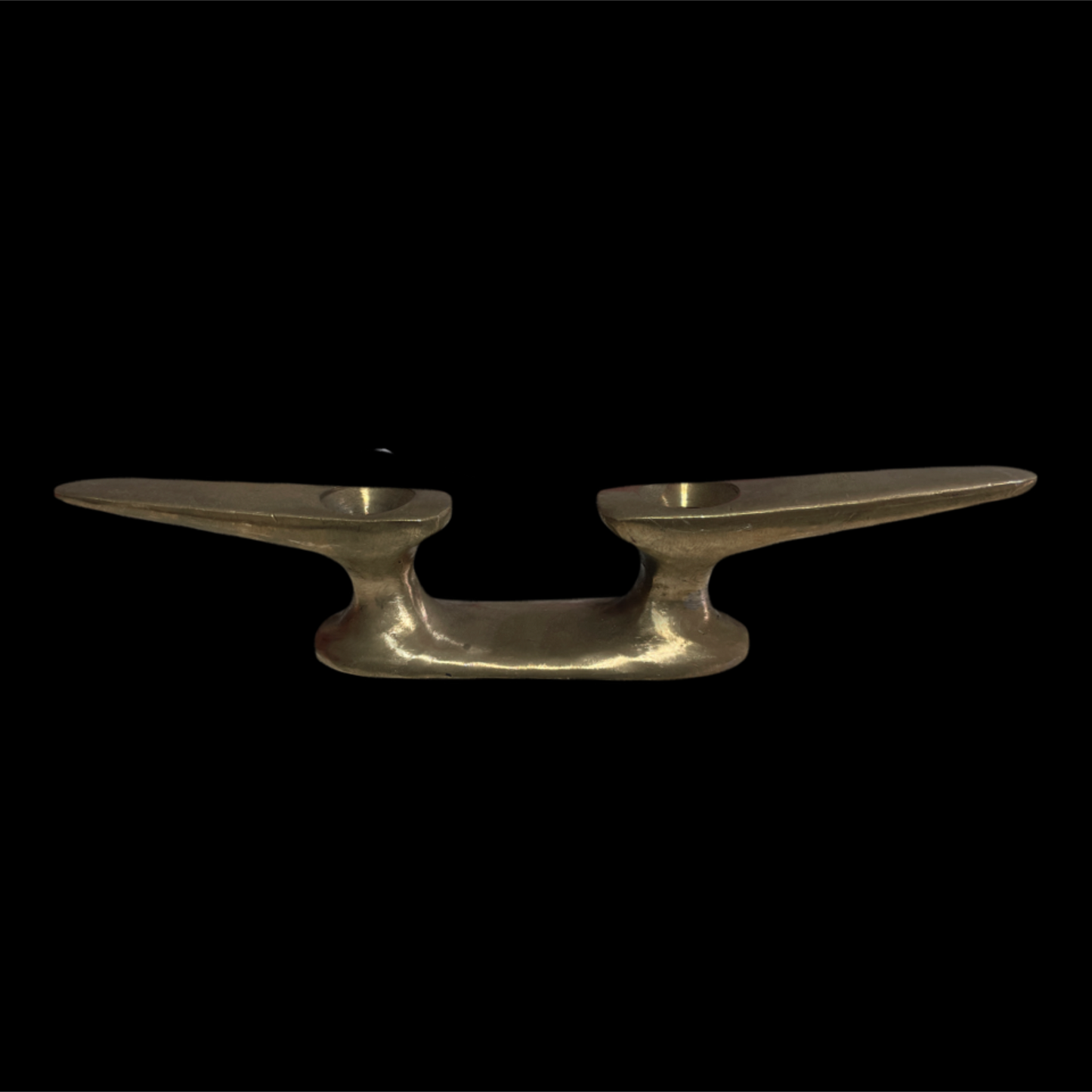 Metallic object resembling a boat anchor on a black background