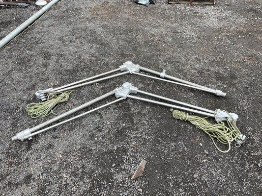 Set of metal rods with rope attachments on a concrete surface