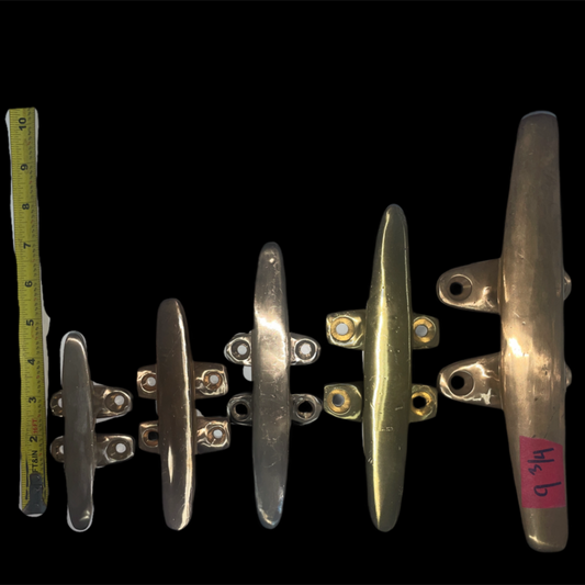 Set of metal cleats with a measuring tape on a black background