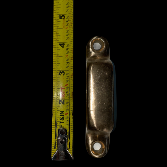 Bronze cleat with a measuring tape on a black background
