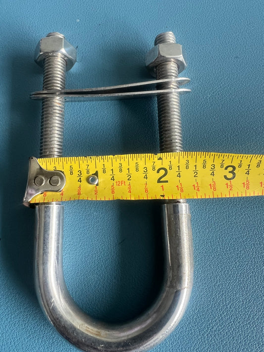 Metal U-bolt with two nuts and a measuring tape on a blue background
